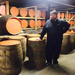 Against the Grain owning partner Sam Cruz picks up his empty brandy barrels at Copper & Kings to begin the aging process for a custom craft beer to serve at Lock, Stock & Smoking Barrels Oct. 30, 2015.
