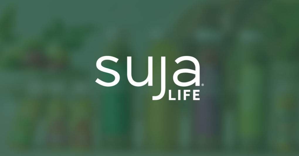 The Suja Life logo on a background of juice bottles.